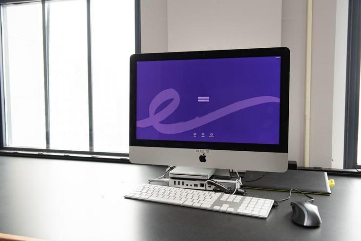 An Apple iMac computer with a keyboard and mouse