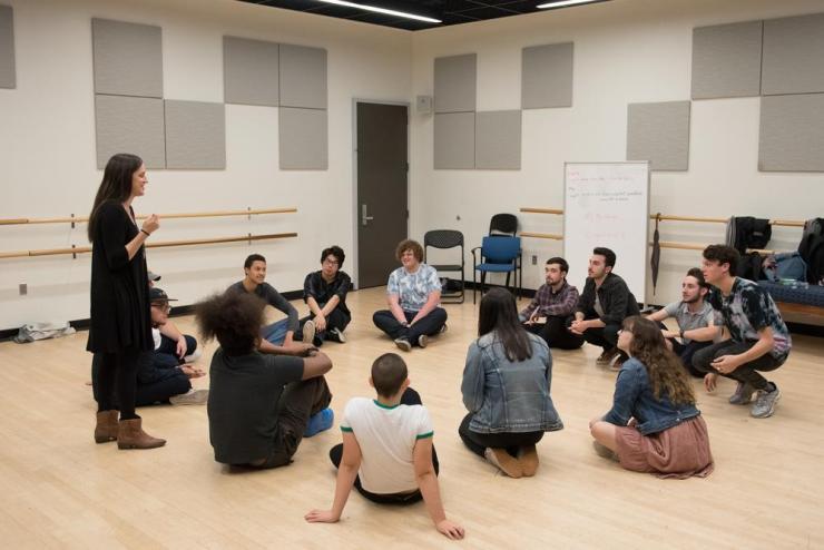 Professor working with students in rehearsal studio