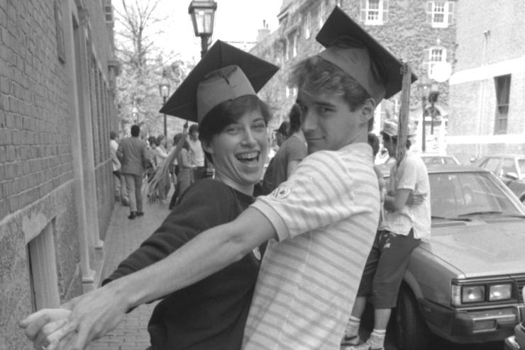 Old black and white photo of two Emerson graduates
