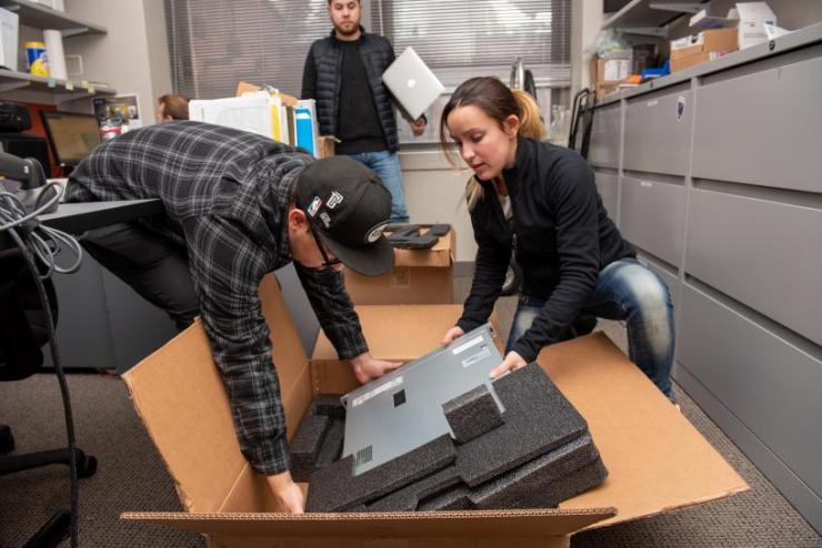Students taking equipment out of boxes