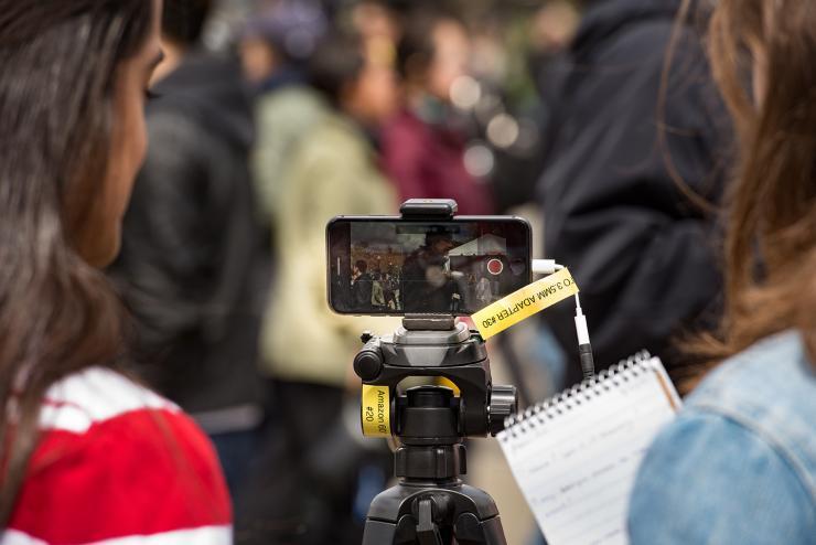 Journalism students film an event
