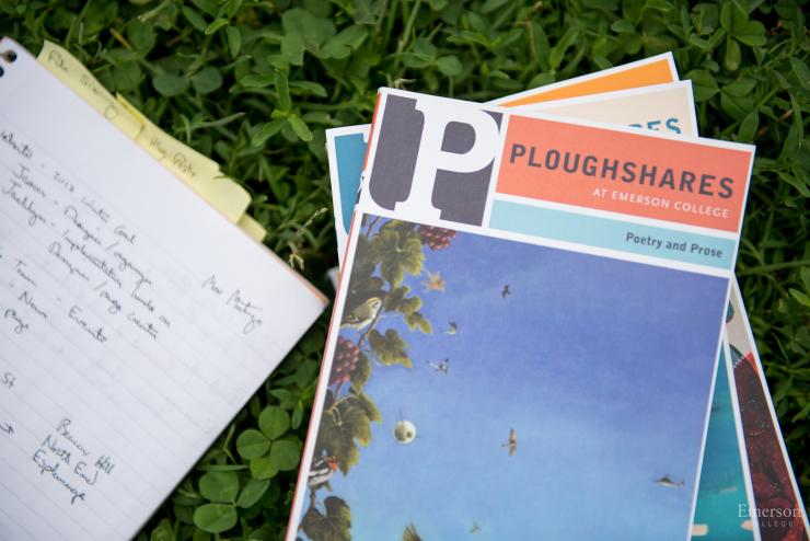 Stack of Ploughshares journals and a notebook in the grass