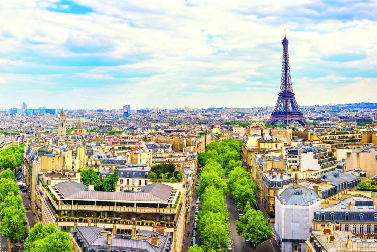 Wide shot of Paris city in broad daylight with a view of the Eiffel Tower in the distance.
