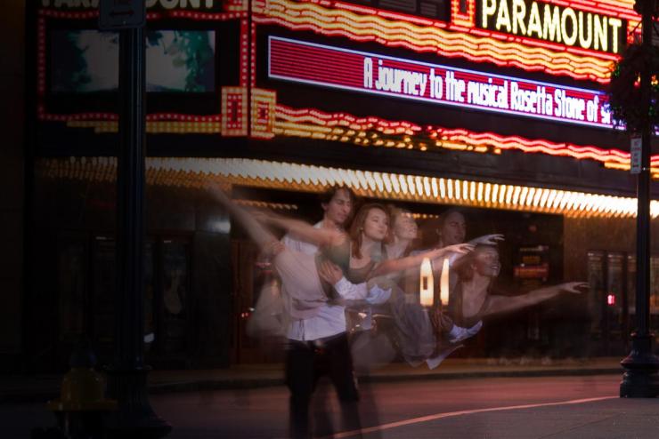 Overlapping images of dancer holding dancer in arms in front of the Paramount theater.