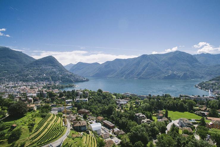 View of Franklin University in Lugano, Switzerland near lake and mountains