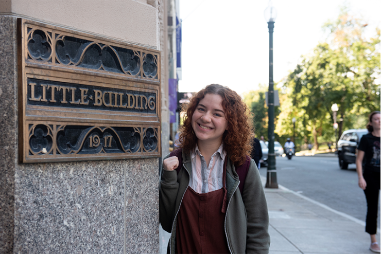 Student facing camera, smiling outside Little Building