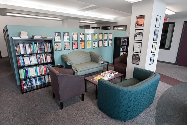 The lounge space in the department of Writing, Literature, and Publishing with chairs and bookshelves