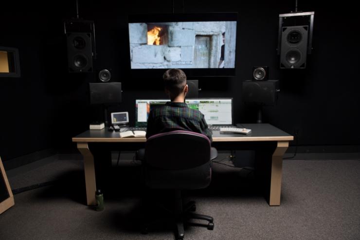 Student working on project in audio post-production suite