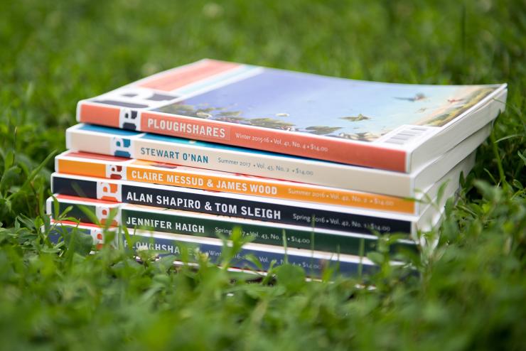 Stack of Ploughshares literary journals sitting in the grass