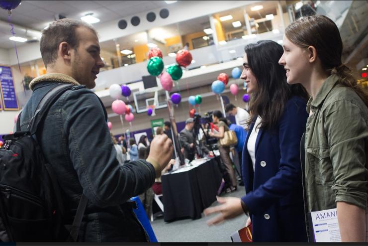 students talk to employer during career day event