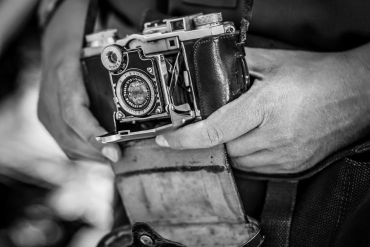 Aged black and white shot featuring an old vintage camera