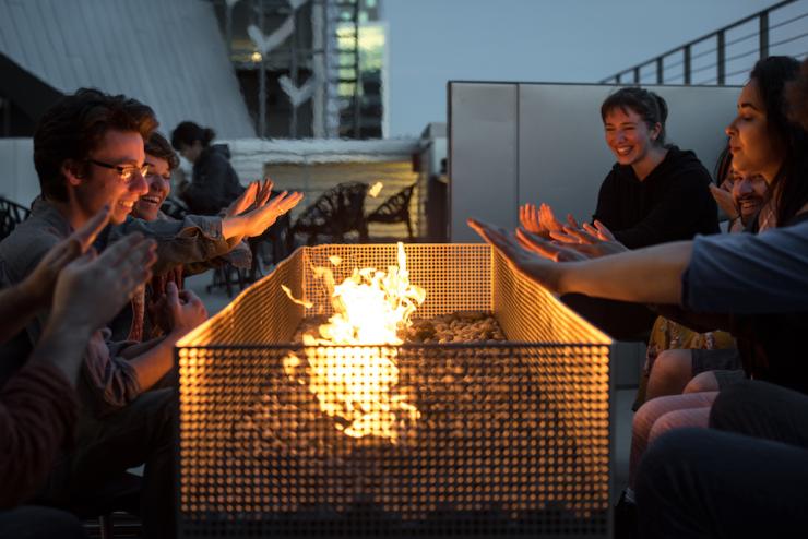 students gather around firepit on outdoor terrace at Emerson Los Angeles