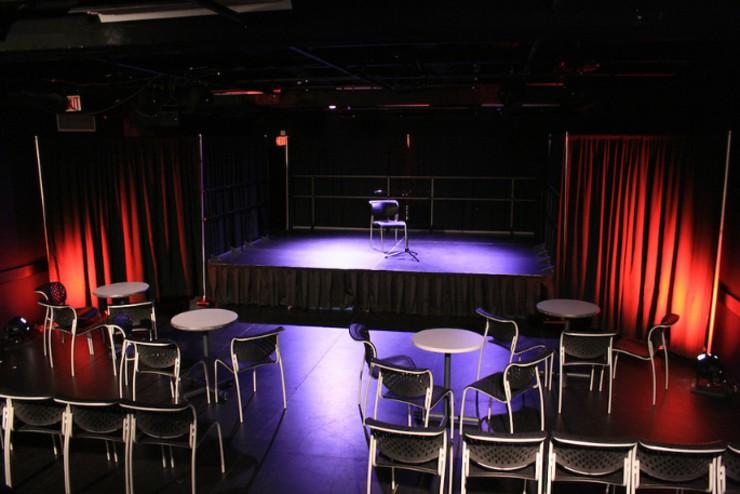 An empty stage and open seating in the Cabaret