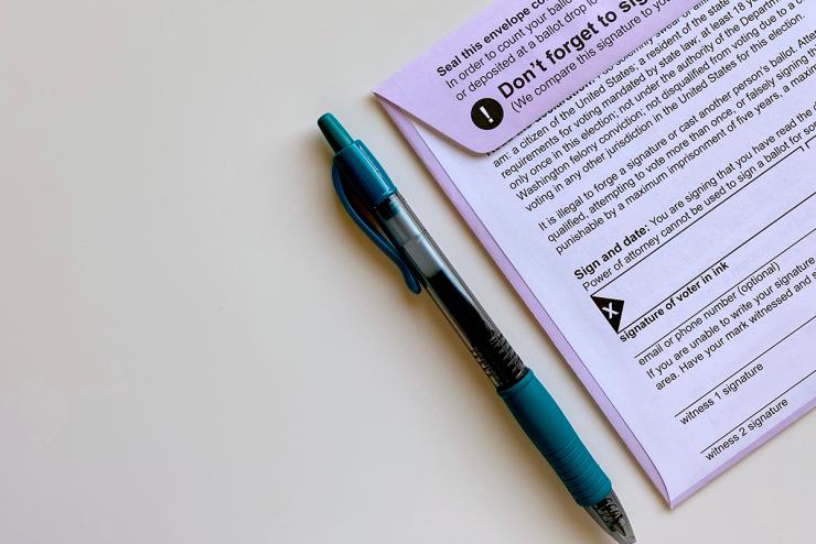 Ballot envelope and pen on table