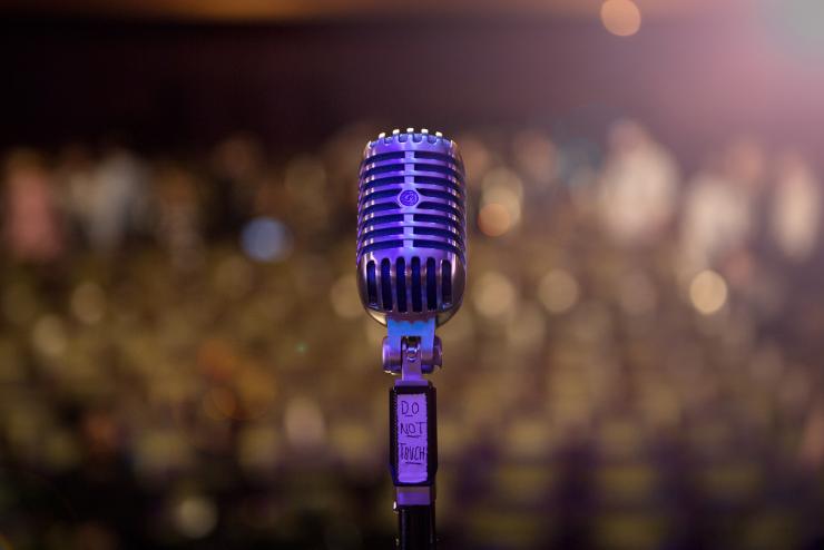 Close-up of microphone on stage, facing audience