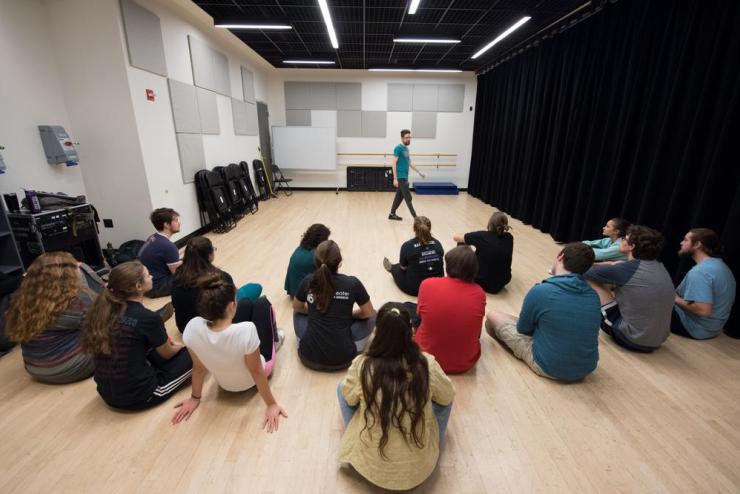 Instructor Matthew McMahan teaching an improv to a mixed group of students within a studio