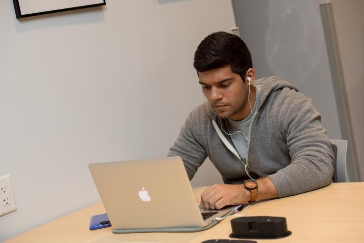 Student sitting at a desk on a laptop