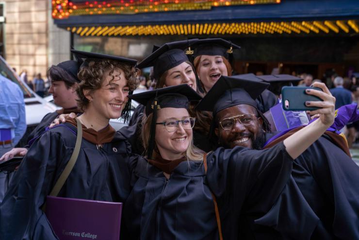 A group of graduates posing for a selfie
