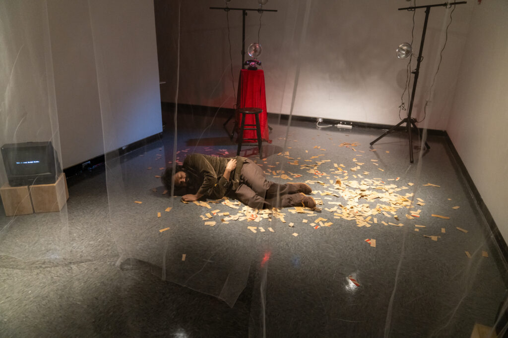 Man lays on ground as part of art exhibit