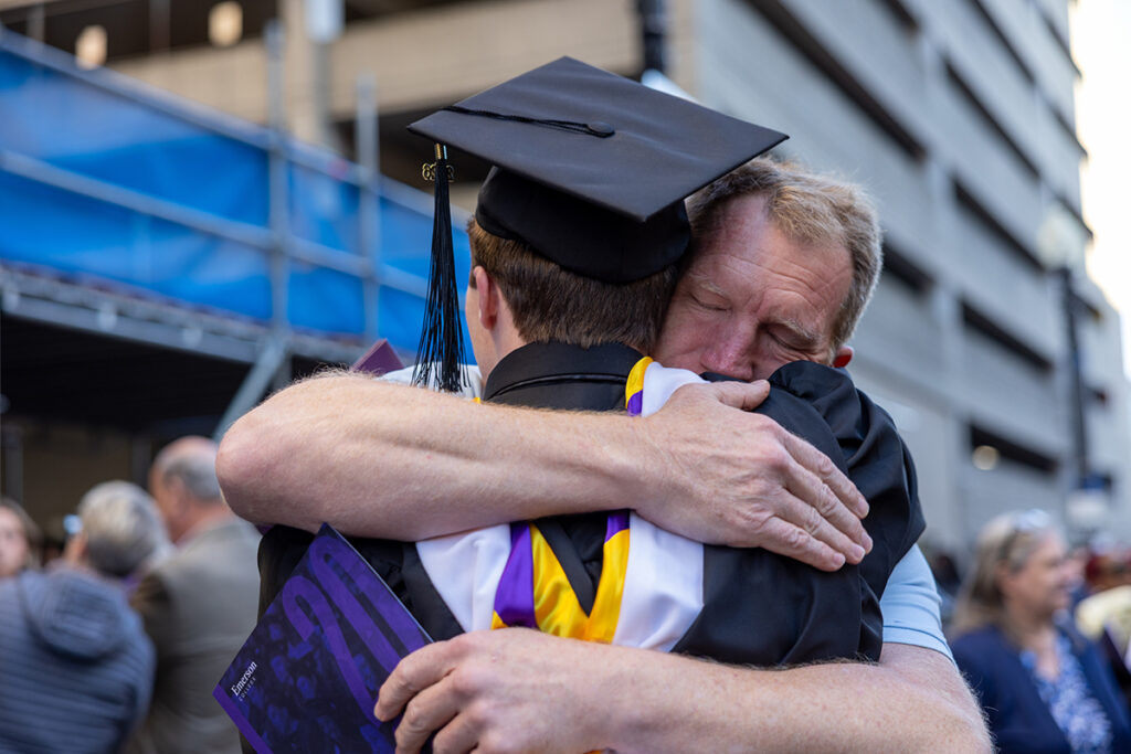 a father hugs a graduate