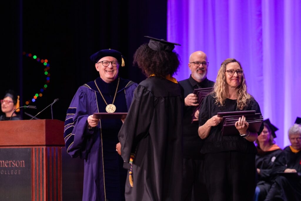 President Jay Bernhardt hands a diploma to an SOF student.