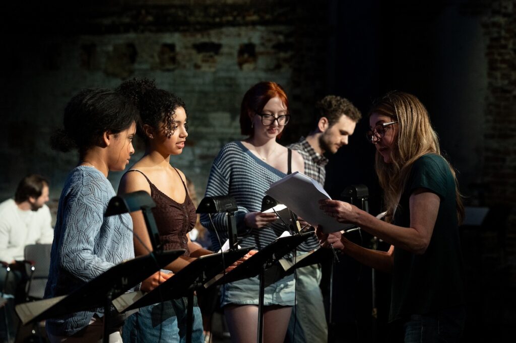 Actress Jane Leeves talks to students during the table reading of script|Students sit in chairs during a table reading of a script||||||