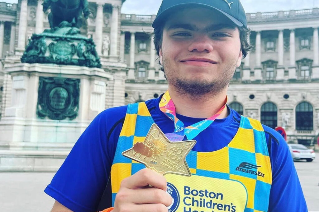 Christiano Iannacone holds his medal from running the Vienna Marathon|Christiano Iannacone shows the medal he won after running a marathon in Vienna|