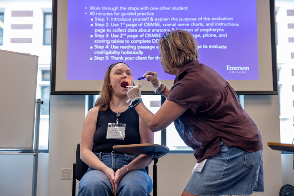 Woman looks in student's mouth