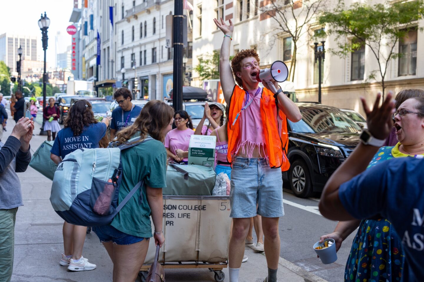 Photo of a student with a megaphone, surrounded by others during move-in