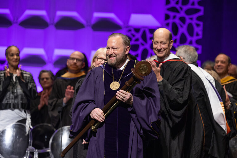 Emerson President Jay Bernhardt holds the staff and baton of office at his official Investiture ceremony on Friday, March 22, at the Cutler Majestic Theatre