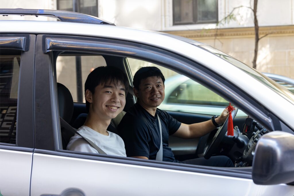 Marco Li and his dad sit in their car