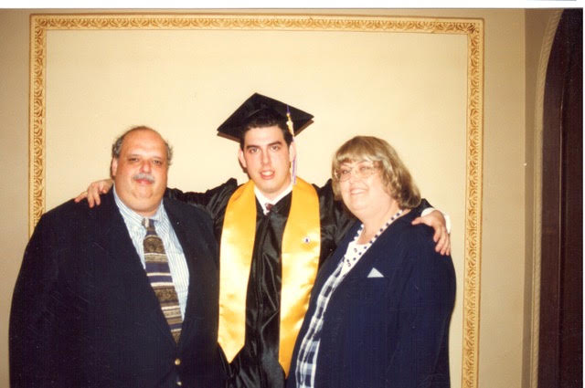 Scott Shiller in cap and gown with his parents
