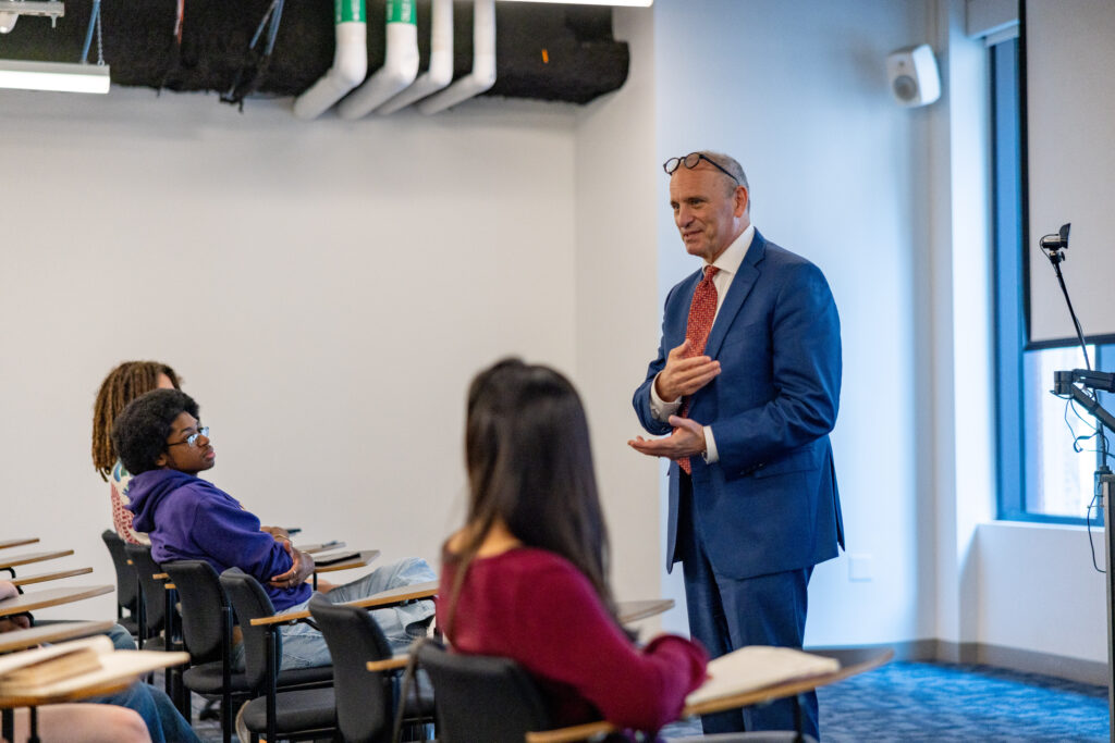 Jonathan Becker speaks to a group of students