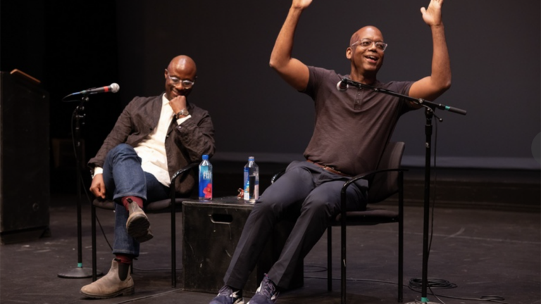 Barry Jenkins and Jewerl Ross speak and gesture on stage