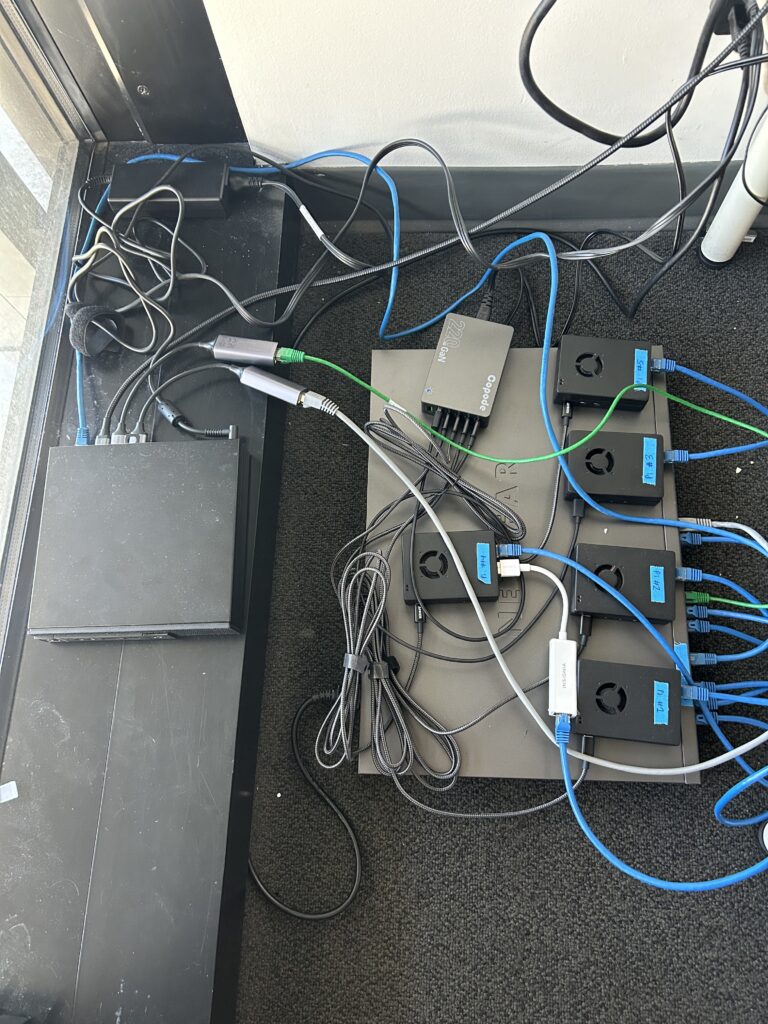 Katz's miniature testing lab he made on his dorm room floor using Raspberry Pi computers, a network switch, and a Dell PC.