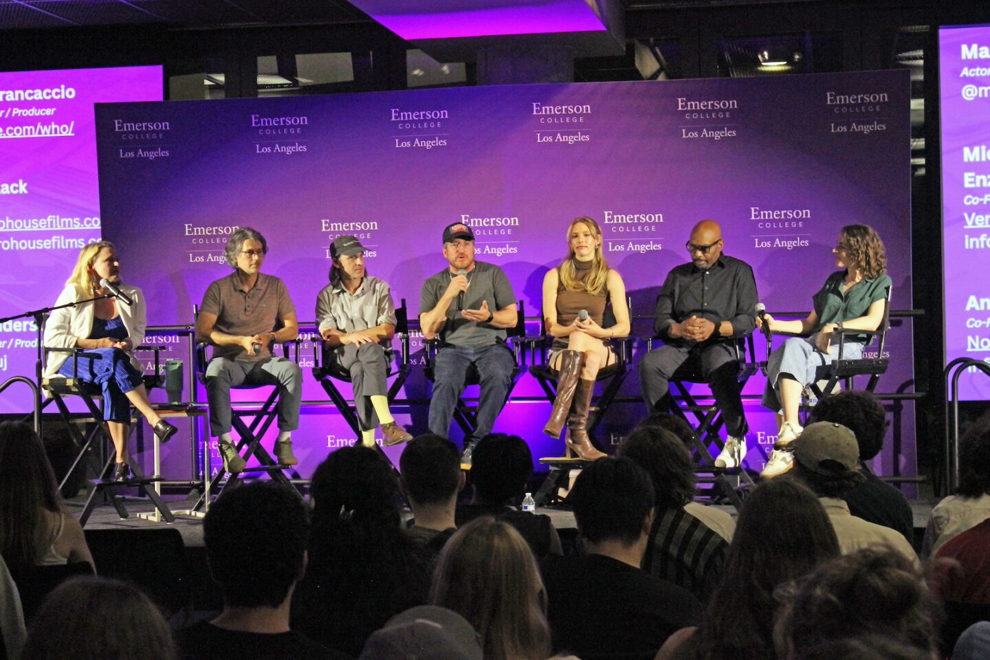 Alumni panelists sit in chairs on a stage at ELA
