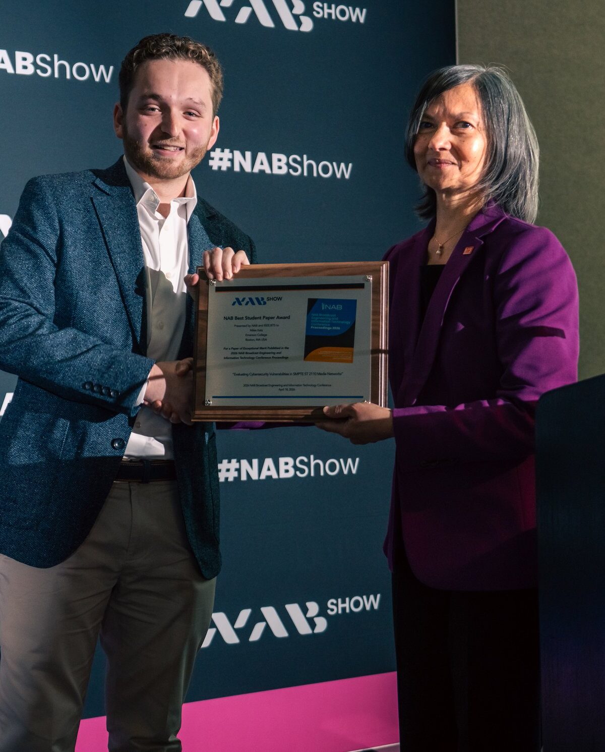 Miles Katz receives an award from a person