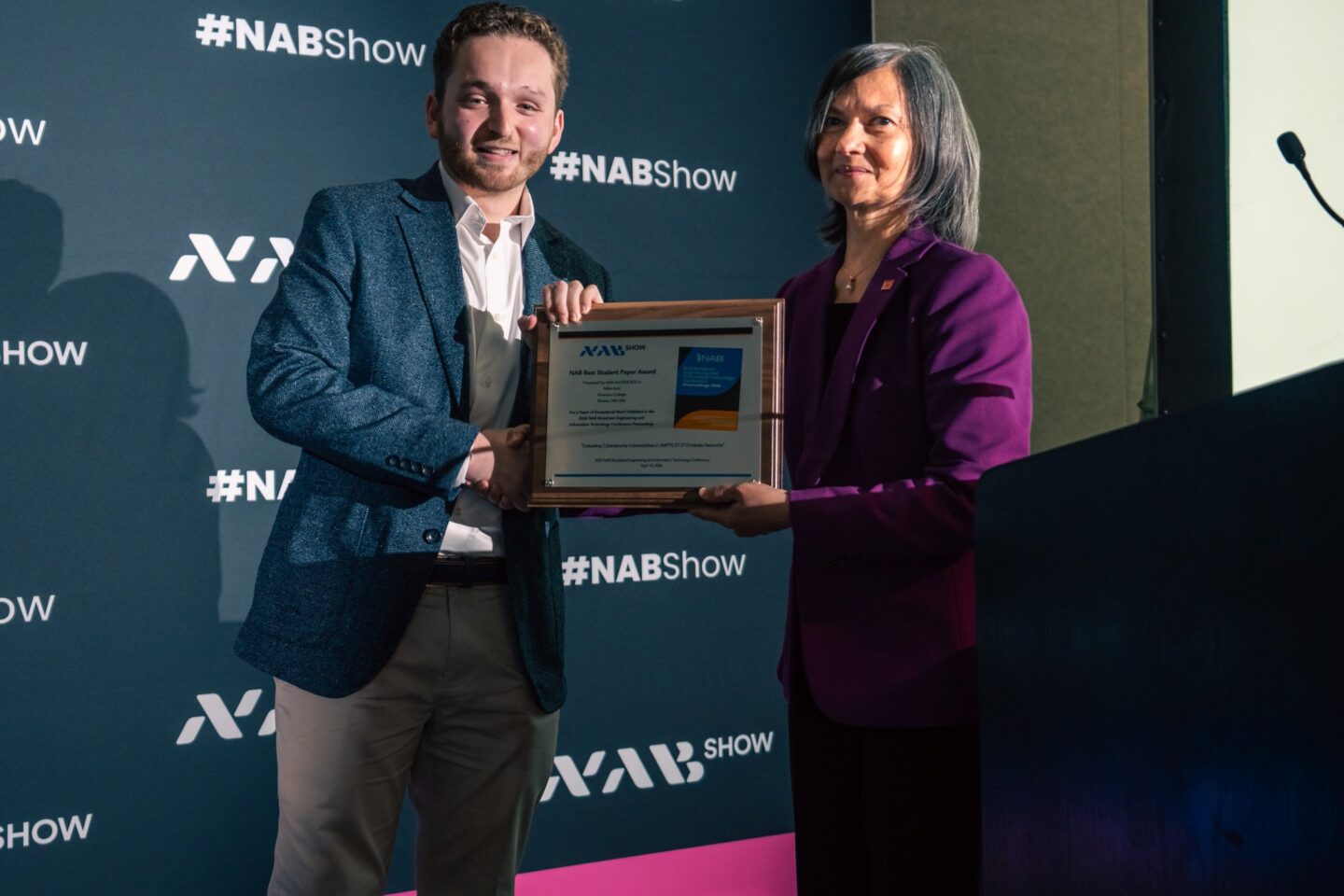 Miles Katz receives an award from a person