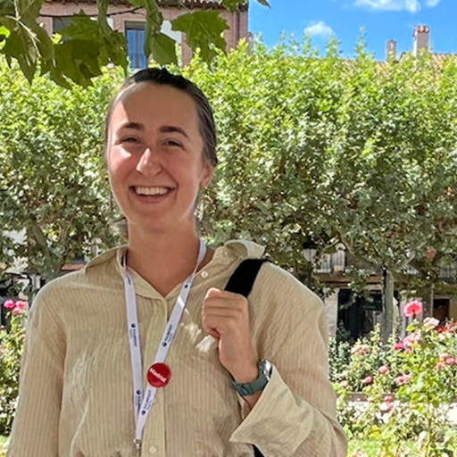 Katherine Holmes in front of building with flowers