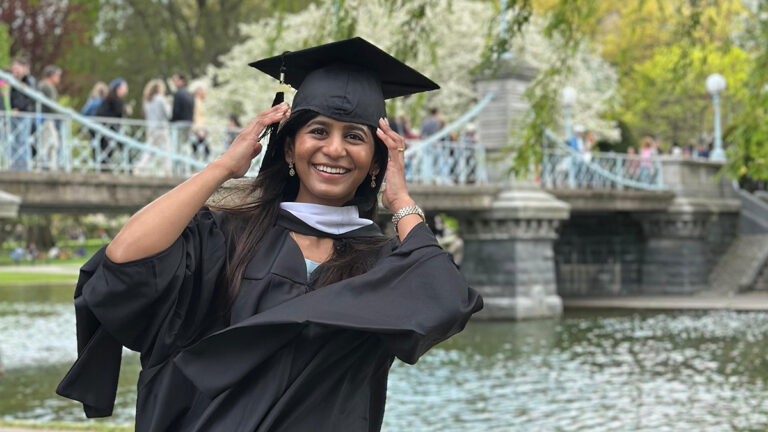 Woman in cap and gown in Boston Public Garden