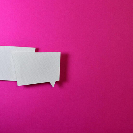 two conversation bubbles against pink background