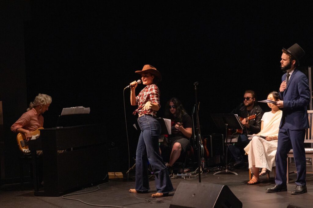 A person dressed as a cowgirl performs