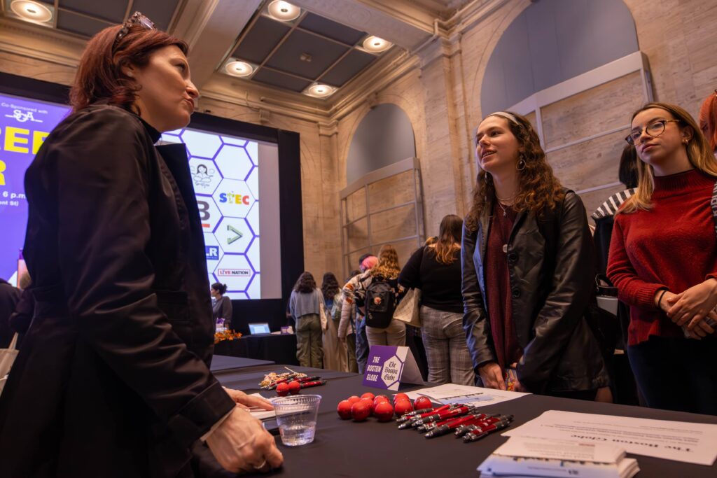 Students speaks with a prospective employer
