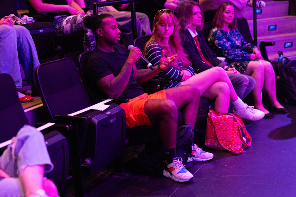 Student in audience speaks into microphone