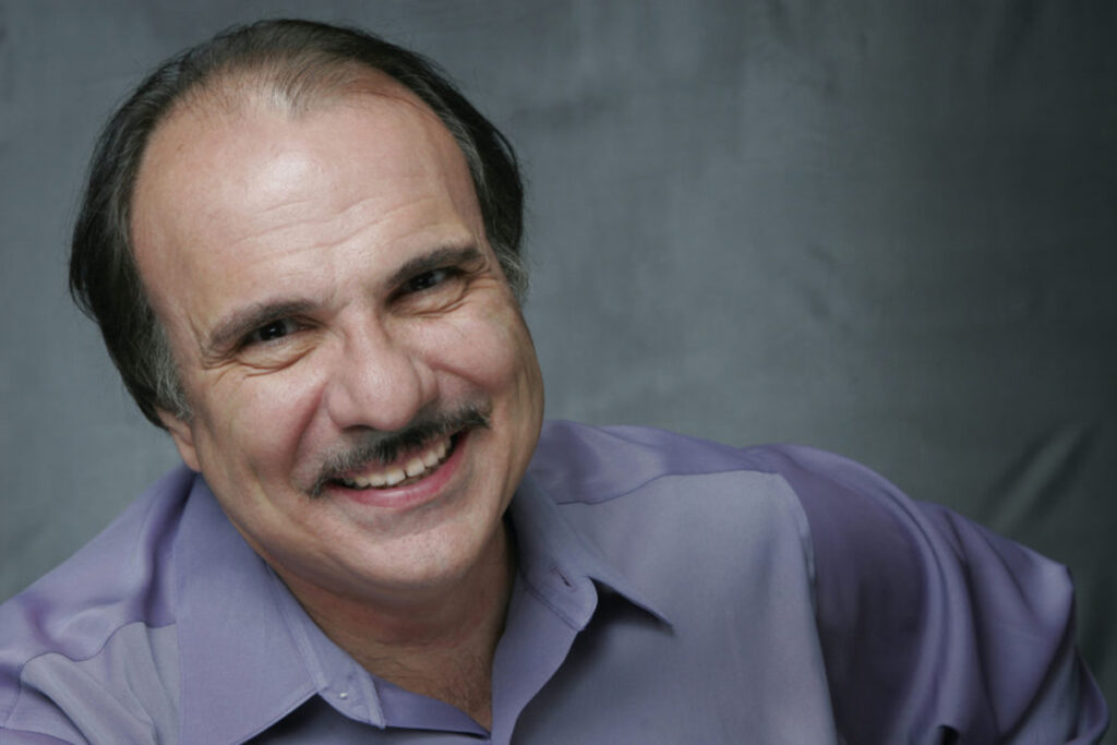 Spiro Veloudos head shot wearing purple shirt
