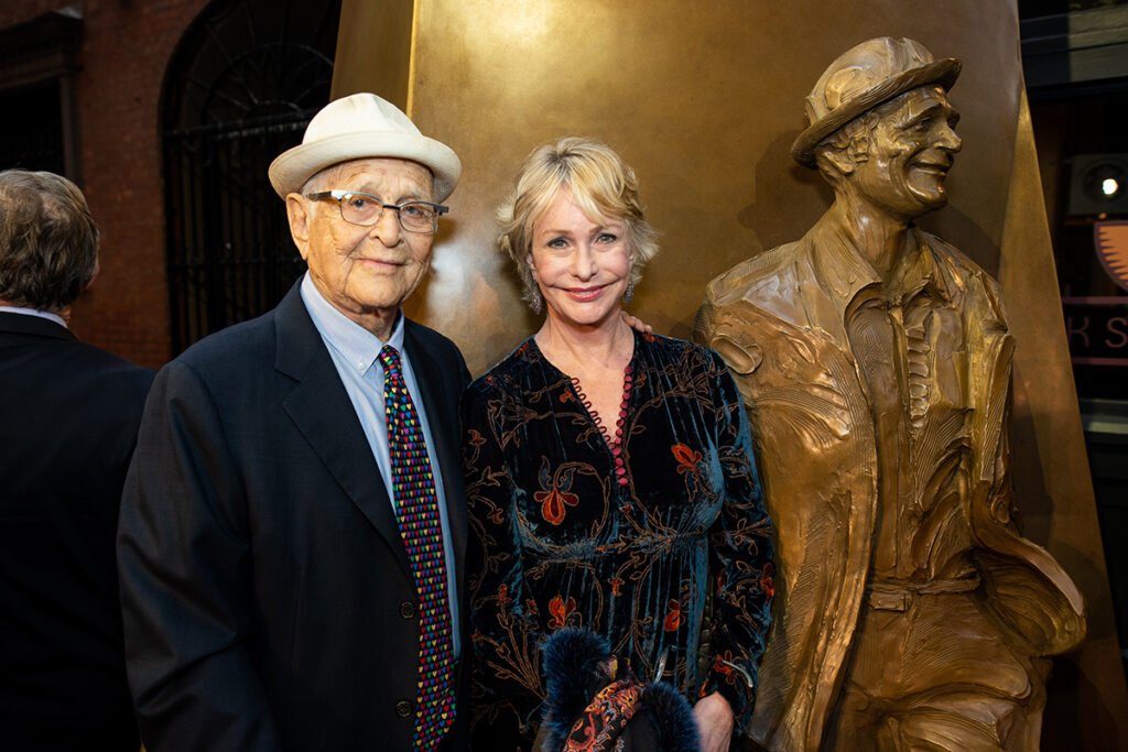 Norman and Lyn Lear in front of Norman's statue