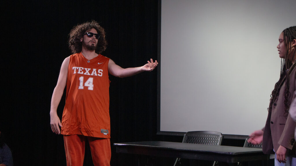 A person reaches out to another during a skit
