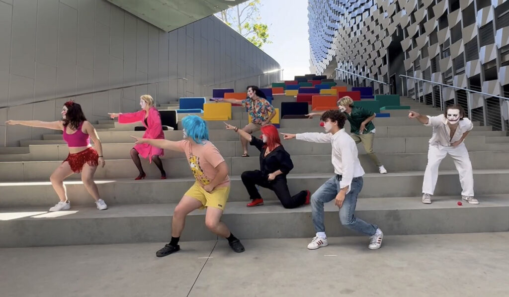 students dressed as clowns dance on steps at Emerson LA