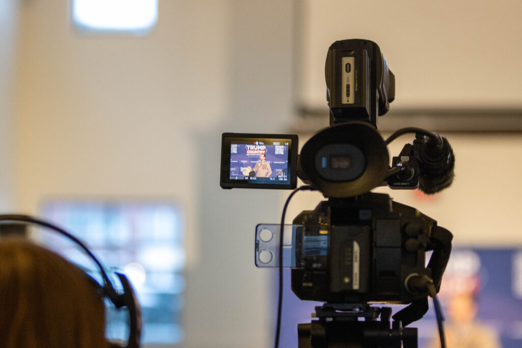 Close up a video camera recording Donald Trump Jr speaking to an audience
