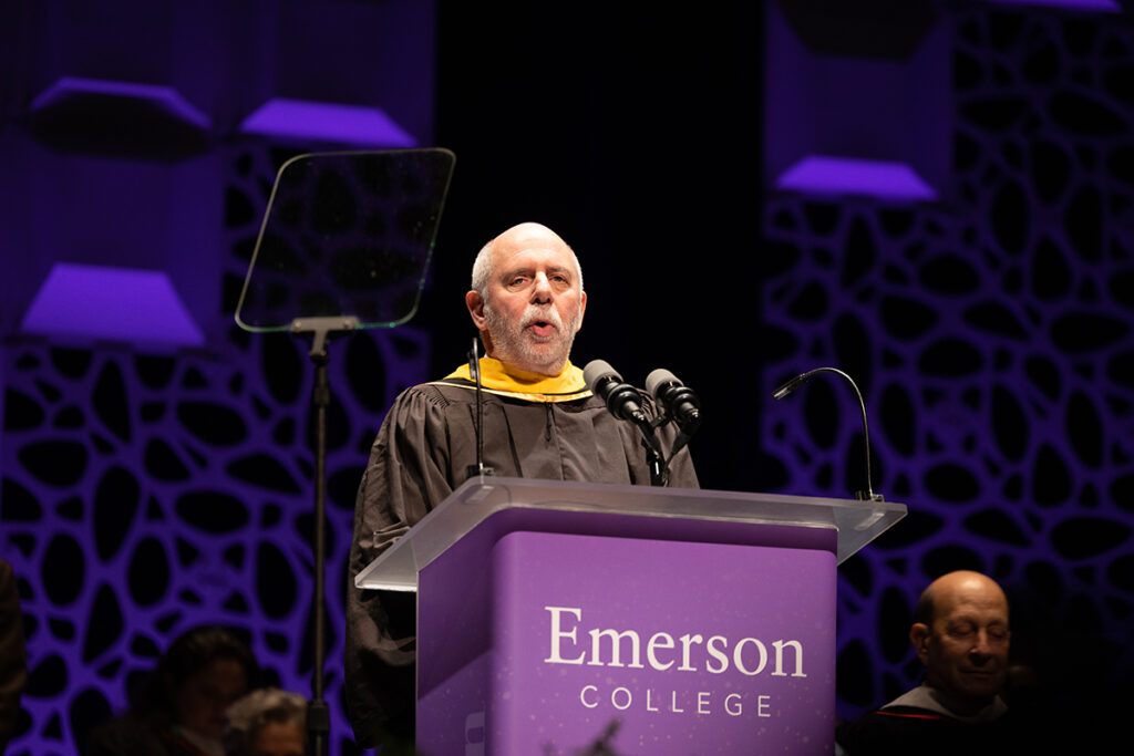 man in robe speaks at podium